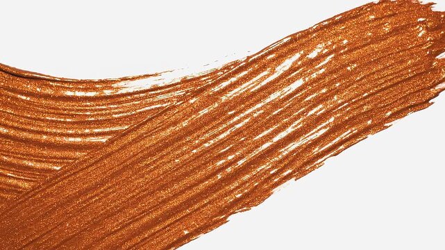 Paintbrush applying metallic bronze glitter paint strokes on a clean white background with copy space, concept of luxury cosmetics and creative art