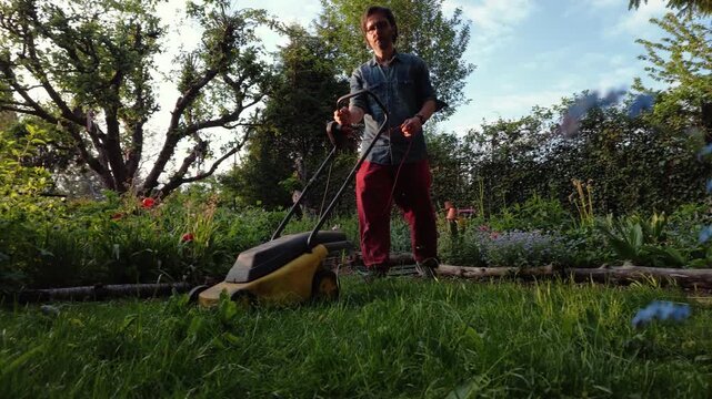 Man Mowing Grass on Garden Allotment
