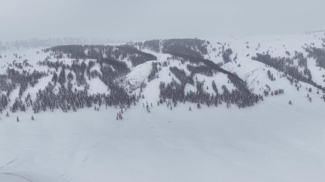 Aerial view of ski slope patterns on snowy mountain in Xinjiang China