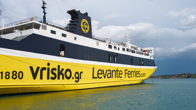 Yellow ferry in blue water, Kyllini, Greece