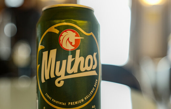 Close-up of a Mythos beer can with logo and green packaging