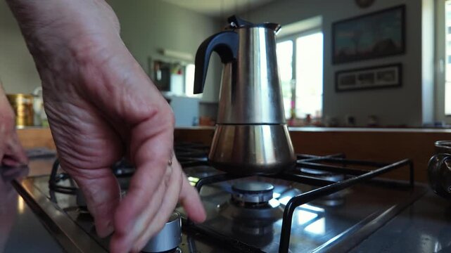 Senior Man Preparing Coffee with Moka Pot on Gas Stove
