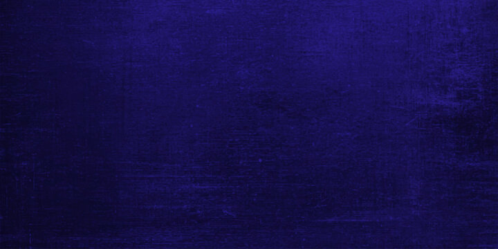 A dark blue canvas and textured denim fabric material background with a vintage grunge paper pattern for backdrop design