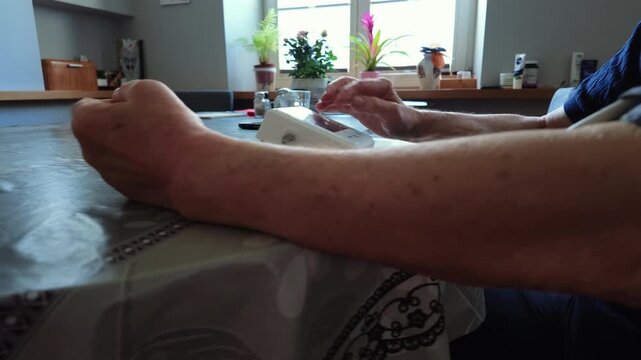 Senior Man Measuring Blood Pressure at Home

