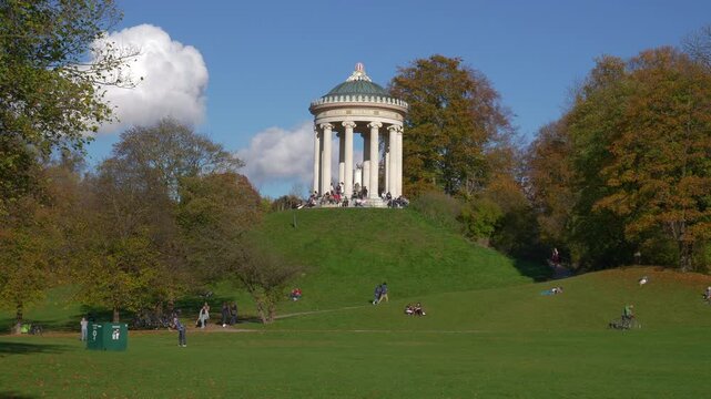 sunny day munich city central park famous rotunda meadow hill slow motion panorama 4k germany 