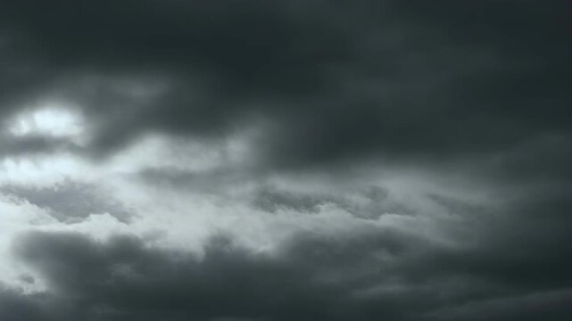 Dramatic dark storm clouds in moody overcast sky.