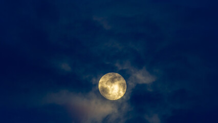 Super full moon in the night sky with clouds, © ric