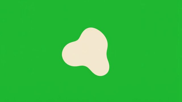 Abstract organic blob shape in cream color isolated on a solid green screen chroma key background.