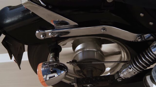 Low Angle View Of Moving Motorcycle Wheel With Chrome Shock Absorber - 4K