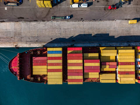Nassau, The Bahamas - 02 June 2026: Aerial view of a large container ship loaded with colorful cargo containers docked at the Arawak Cay port facility.