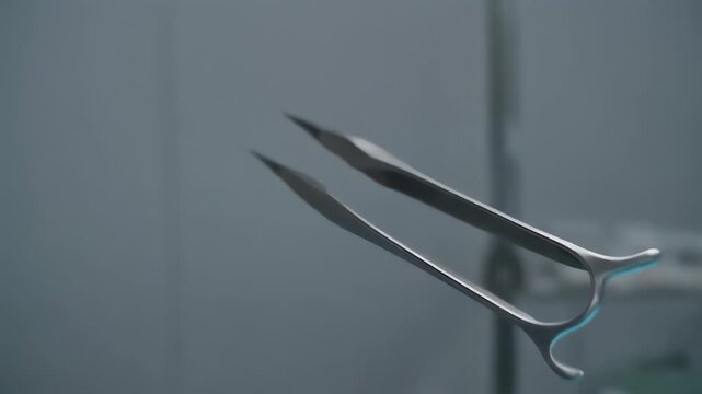 A pair of precision dental forceps floats in a blurred clinical setting, stainless steel blades tapering to slim, curved tips that catch cool light and form a minimalist, sterile medical scene. serene