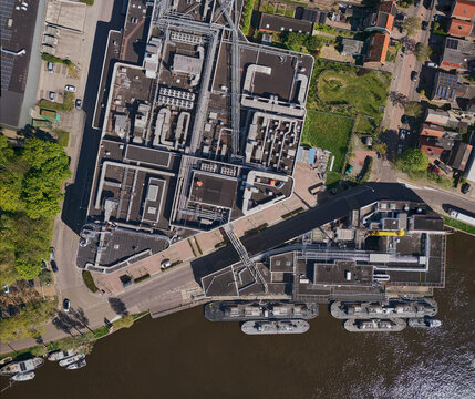 Wormer, Netherlands - 02 June 2026: Aerial view of the Cargill cocoa factory Gerkens on the Zaan river, showing industrial rooftops, piping systems, and barges at the waterfront.