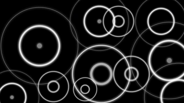 Animation of several white circular waves radiating and decaying from a central wave source, against a black background. Locations of seismic activity.