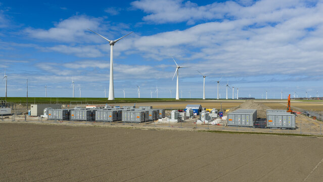 Espel, Netherlands - 04 April 2026: Aerial drone view of a large battery park near Windpark Noordoostpolder, showing renewable energy storage, grid balancing, containers and transformers.