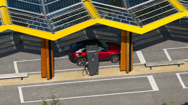 Darp, Netherlands - 23 May 2026: Aerial drone view of a Fastned fast charging station along the highway, showing DC EV charging, electric mobility, clean transport and highway infrastructure.