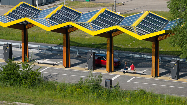 Darp, Netherlands - 23 May 2026: Aerial drone view of a Fastned fast charging station along the highway, showing DC EV charging, electric mobility, clean transport and highway infrastructure.