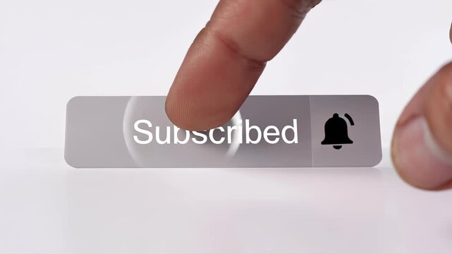 Close-up of a finger pressing the notification bell icon on a subscribed button for online content updates