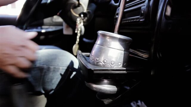 Driver Hand on Gear Shift Next to Traditional Mate Gourd in Vehicle - 4K