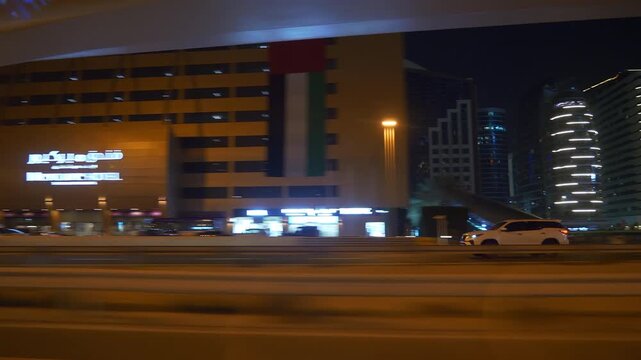 night life time illuminated dubai city traffic street road trip side window pov panorama 4k uae