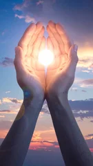 Open Hands Holding Bright Sunlight Against Colorful Sunset Sky © subur