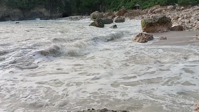 Powerful Ocean Waves Crashing on Rocky Beach Shoreline
