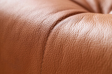 Fototapeta premium Texture of brown leather sofa, closeup