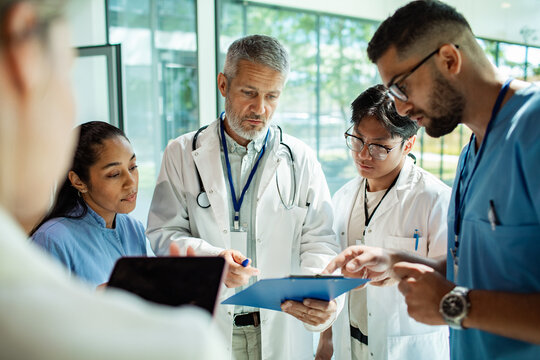 Healthcare team reviewing patient chart in hospital