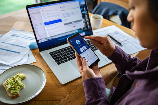 Woman managing online banking and bills at home workspace