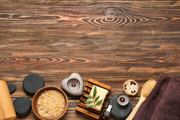 Obraz na płótnie Canvas Composition with spa stones, candles, spoon and bowl of sea salt on wooden background