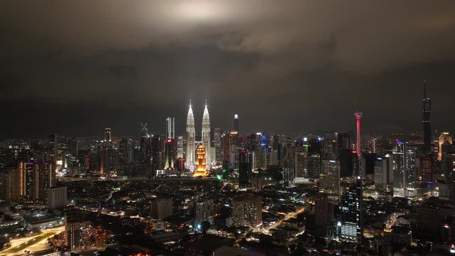 night time illumination kuala lumpur city downtown famous towers district aerial panorama 4k malaysia    