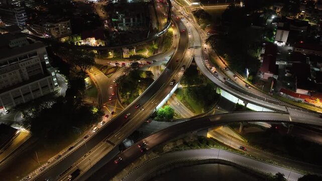 night time illuminated kuala lumpur city traffic street road interchange aerial panorama 4k malaysia    