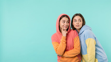 Naklejka premium Playful Lesbian Couple Looking At Copyspace On Turquoise Background