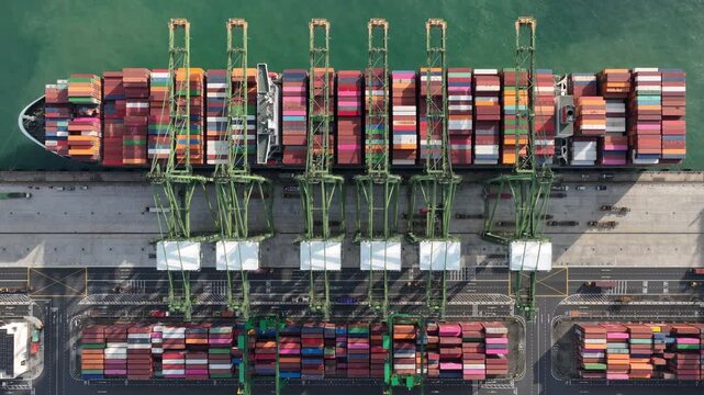 sunny day singapore city port terminal container ship loading working cranes bay aerial topdown panorama 4k    
