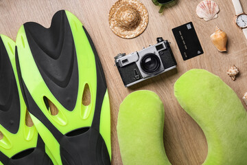 Traveler's accessories with credit card and seashells on wooden floor, top view © Pixel-Shot