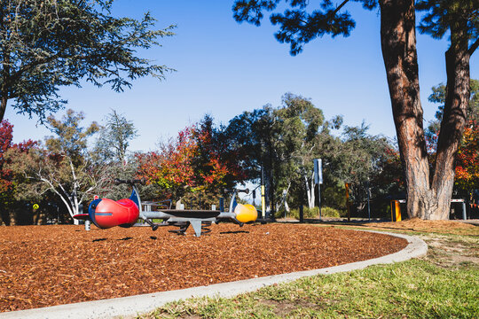 Colorful Playground Seesaw in Park on Sunny Autumn Day - Left Low Angle
