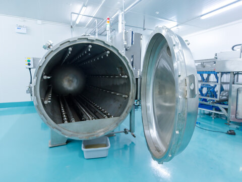 Industrial stainless steel retort sterilizer open chamber modern food processing facility advanced thermal treatment equipment product sterilization quality assurance safe packaging production factory