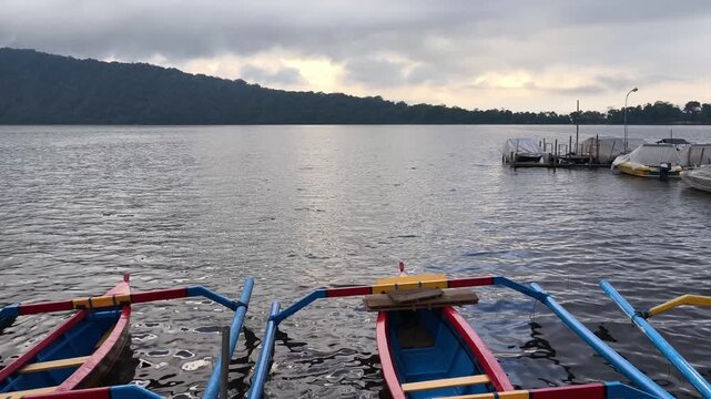 Traditional Balinese Jukung Boats on Lake Beratan in Bedugul Bali under Cloudy Sky