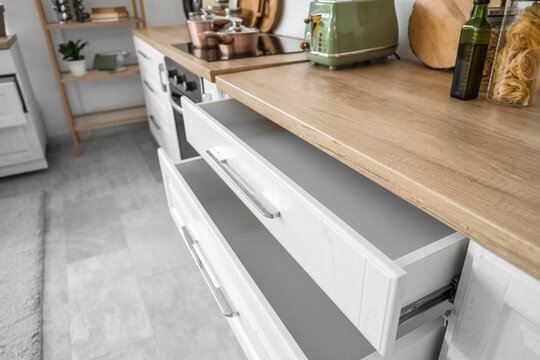 Counter with open drawers in kitchen, closeup