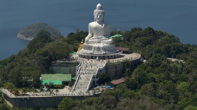 sunny day phuket island famous crowded park mountain top big buddha monument front aerial panorama 4k thailand