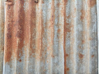 Naklejka premium Corrugated Metal Sheet with Rust and Weathered Texture.