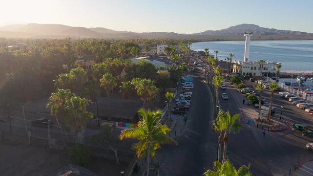 Watch aerial views of the sunset in Loreto Baja California Sur Mexico showing the waterfront, harbor, and palm trees at the marina