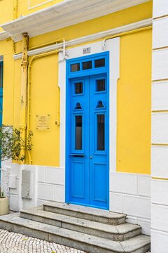 Beautiful traditional blue wooden door on yellow facade of historic Chapel of St Francis Xavier built in 1928 at Coloane village in Macau China