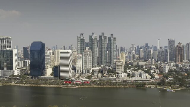 sunny day flight over bangkok city center famous park lake aerial panorama 4k timelapse thailand