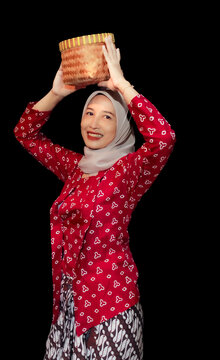 A Women Holding traditional woven bamboo basket (bakul).