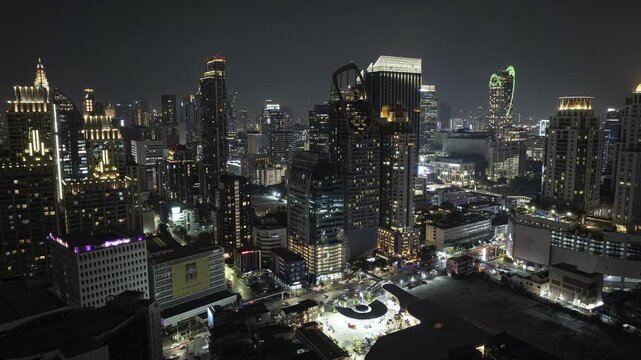 night life illumination flight over bangkok city downtown traffic street aerial panorama 4k timelapse thailand