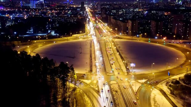 Ekaterinburg, Russia. Crossroads in the form rings. Interchange at night. Active traffic. Drone footage