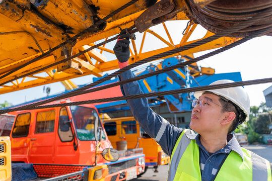 Inspecting crane cable worker safety construction maintenance equipment