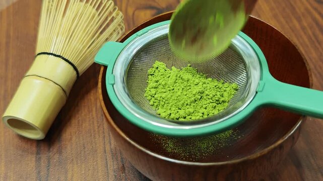 The process of brewing matcha green tea.