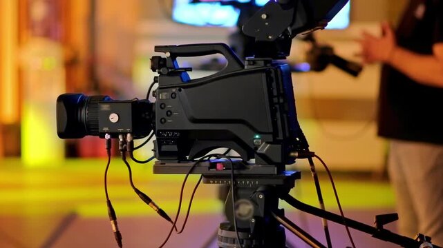 Professional broadcast camera setup recording inside television studio setting.