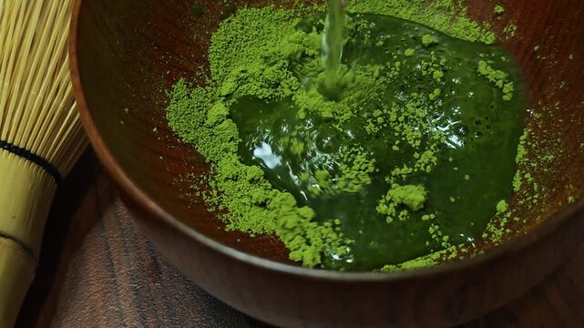 The process of brewing matcha green tea.